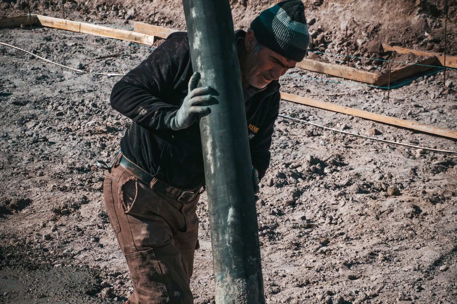 Boom pump placing concrete on a deck