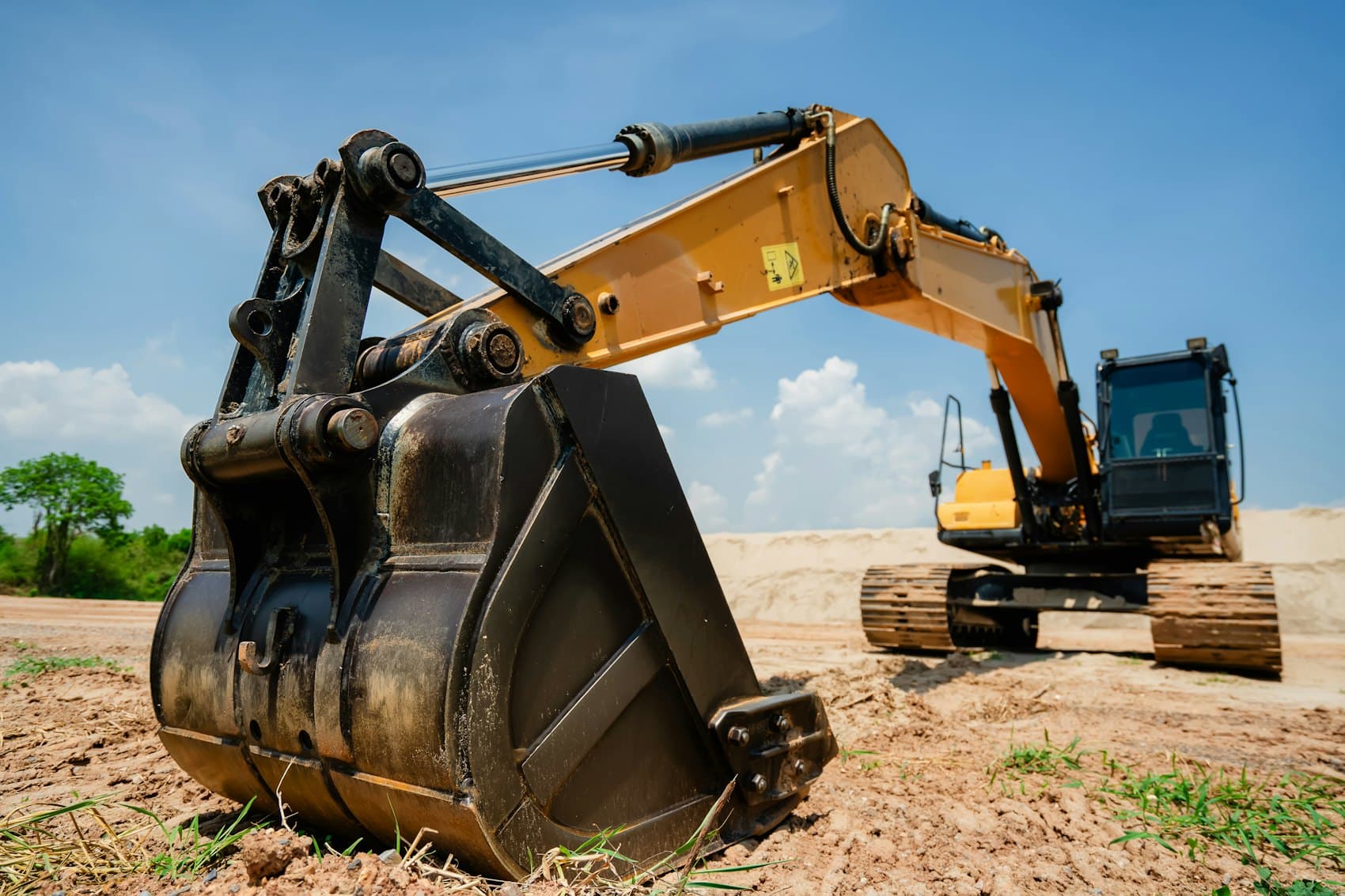Excavator moving earth on a cleared site