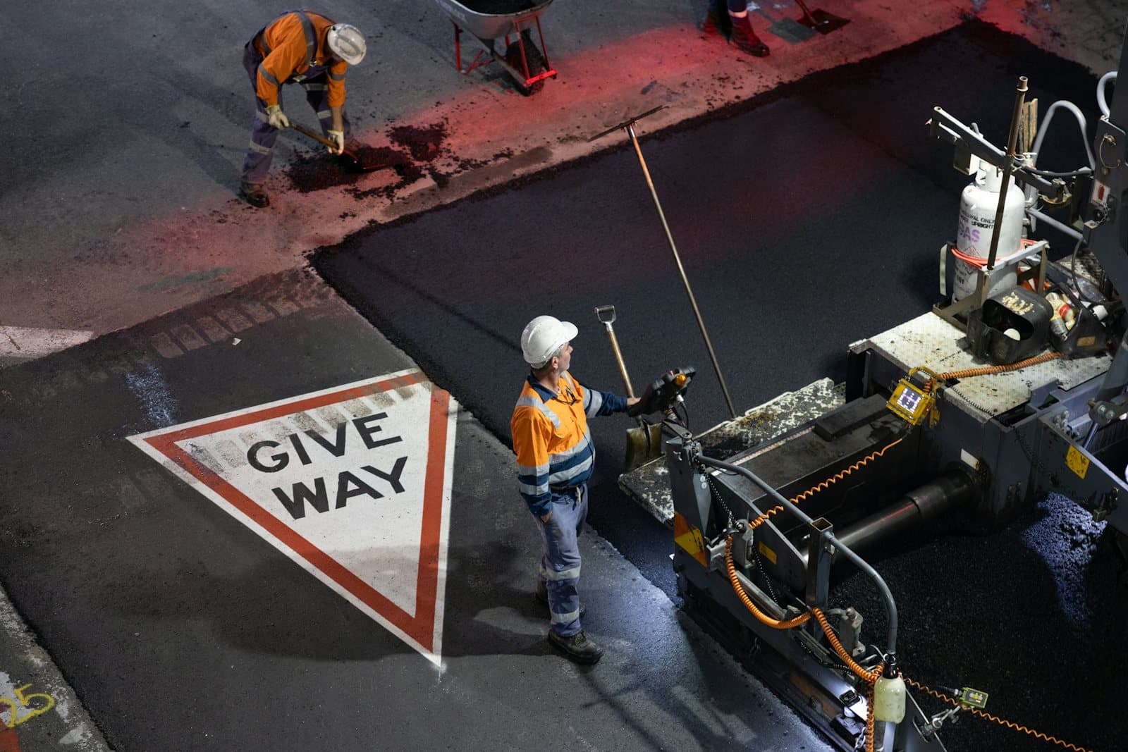 Paving crew laying asphalt on a highway